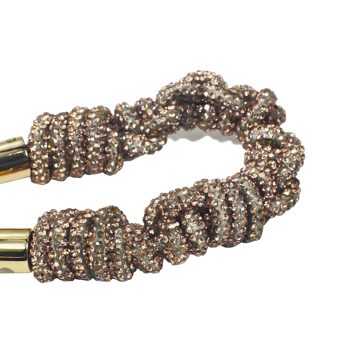 Close-up of sparkling braided crystal strands with golden clasp