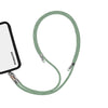 Adjustable mint green phone crossbody strap connected to iPhone charging port
