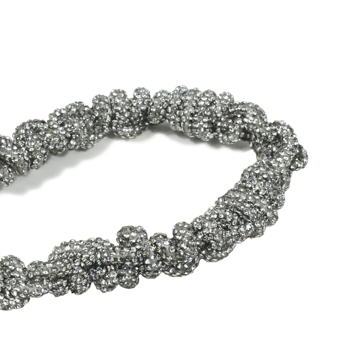 Artisanal crystal braiding detail with silver metal clasp